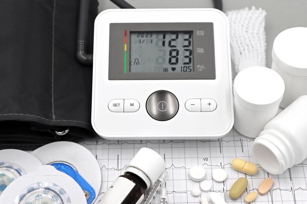 Blood pressure monitor, cardiac medication pills, and ECG printout illustrating chronic disease therapy growth in India's pharma market