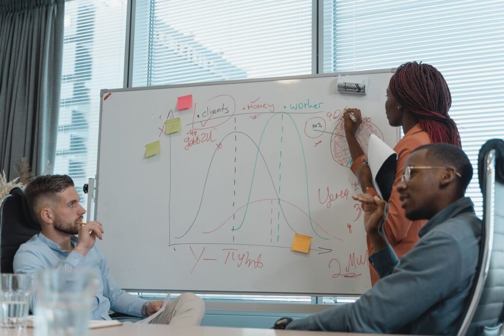 How to Evaluate a Pharmaceutical Digital Marketing Agency 2 Diverse marketing team collaborating at a whiteboard to plan agency versus in-house digital strategy