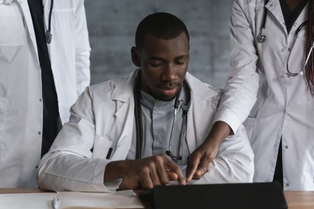 How to Evaluate a Pharmaceutical Digital Marketing Agency 4 Medical professionals reviewing data on a tablet in a clinical setting, representing HCP data handling and digital engagement in pharma marketing