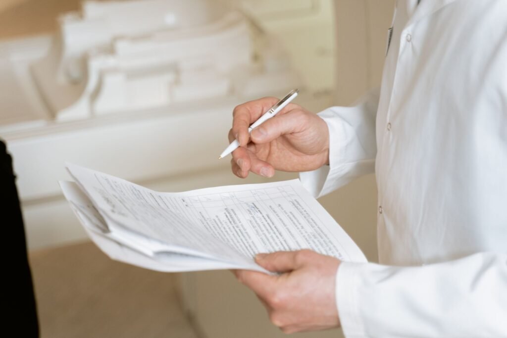 How to Evaluate a Pharmaceutical Digital Marketing Agency 3 Doctor in white coat reviewing printed regulatory documents with a pen, representing pharma compliance review under UCPMP 2024
