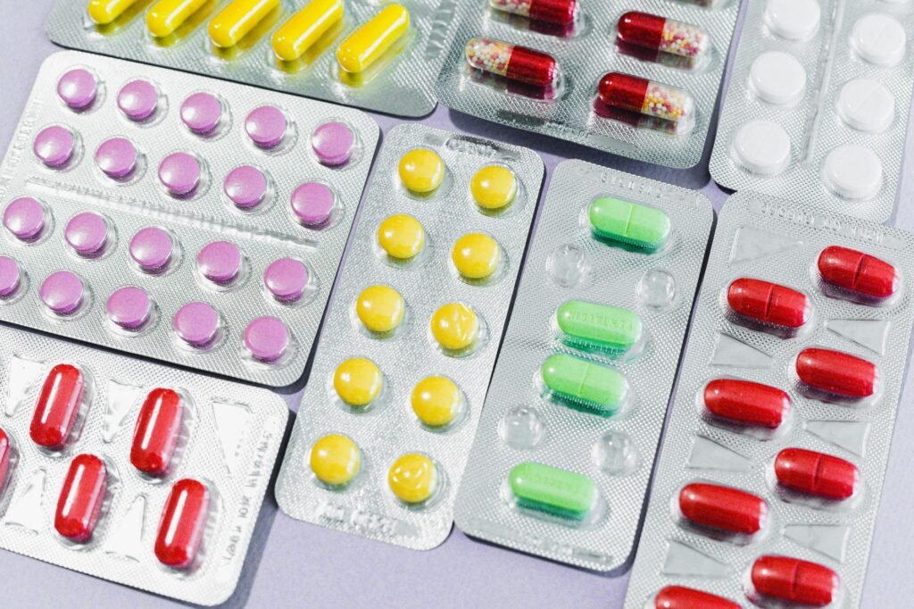 Colorful blister packs of generic tablets and capsules representing the diversity of India's pharmaceutical formulations market