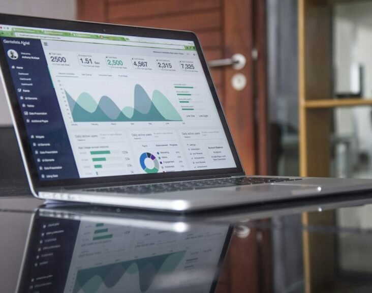 Analytics dashboard on a laptop displaying sales metrics and KPI charts, representing pharma field force effectiveness measurement