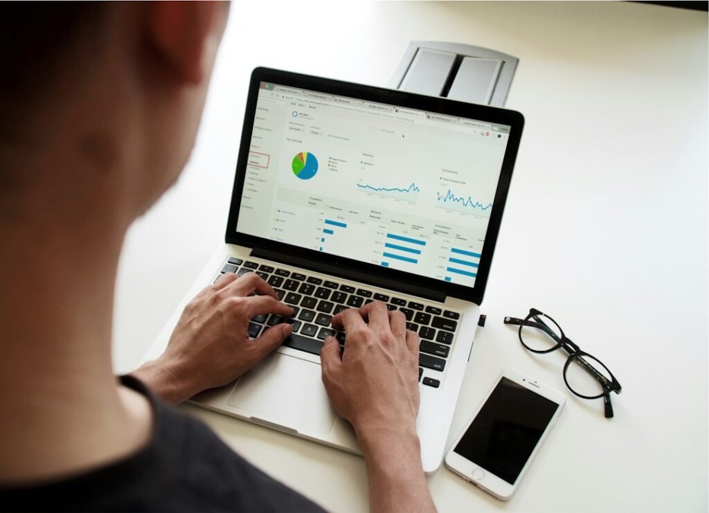 Pharma Brand Manager Roles & Responsibilities India 2 Brand manager reviewing pharma sales performance data and charts on a laptop