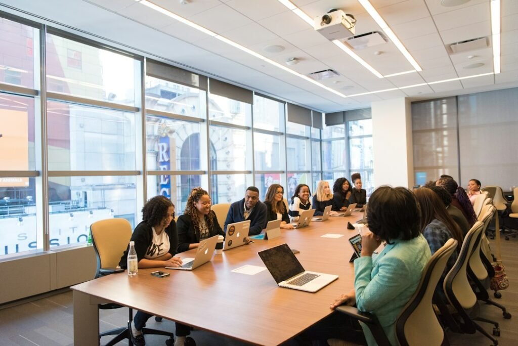 Omnichannel HCP Engagement Framework: 5 Layers, 90 Days 4 Cross-functional team with laptops in a modern conference room, representing the coordinated planning required for a 90-day omnichannel pharma rollout