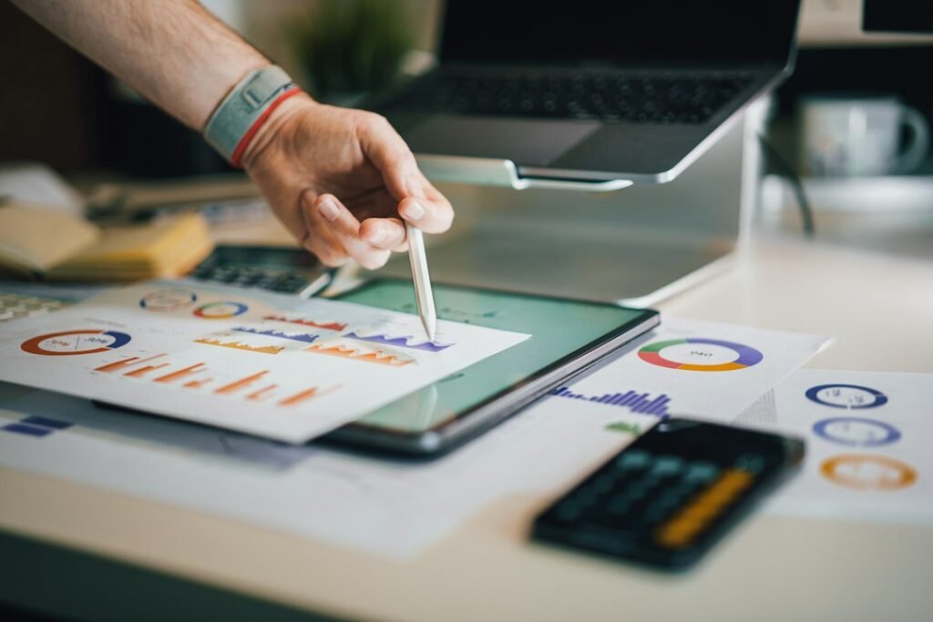 Pharma Brand Manager Roles & Responsibilities India 3 Pharma brand manager reviewing monthly IQVIA and Pharmarack sales data reports on tablet with charts